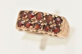 A YELLOW METAL GEM SET RING, two rows of five circular cut garnets, prong set in yellow metal,