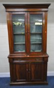 AN EARLY 20TH CENTURY MAHOGANY BOOKCASE, with double glass doors, atop a base with a single drawer