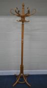 A THONET STYLE BEECH COAT / HAT STAND, with six arms, raised on four splayed legs, height 190cm,