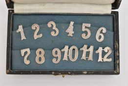 A CASED SET OF CONTINENTAL WHITE METAL GLASS MARKERS, textured numbers one to twelve, each stamped