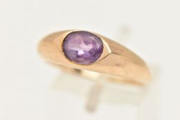 A 9CT GOLD AMETHYST RING, an oval cut purple amethyst half bezel set in yellow gold, hallmarked