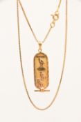 A YELLOW METAL EGYPTIAN CARTOUCHE PENDANT AND CHAIN, the pendant fitted with a tapered bail, stamped