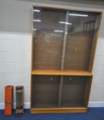 A TWO TIER COLLECTORS DISPLAY CABINET, each tier with double sliding doors, twenty-two shallow glass