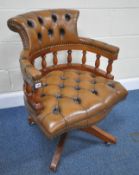 A LATE 20TH CENTURY TANNED LEATHER SWIVEL OFFICE CHAIR, with a bow top, raised on five legs with