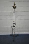 A WROUGHT IRON TELESCOPIC STANDARD LAMP, converted from an oil lamp, maximum height 188cm, minimum