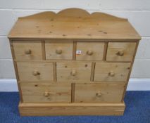 A MODERN PINE BANK OF NINE ASSORTED DRAWERS, width 87cm x depth 34cm x height 96cm, condition
