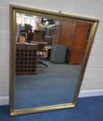 A LARGE GILT WOOD RECTANGULAR BEVELLED EDGE WALL MIRROR, 134cm x 103cm, general signs of usage to