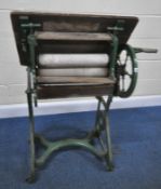 A LEWIS'S GREEN PAINTED CAST IRON CLOTHES MANGLE, with an arrangement of rollers, gears, wooden