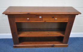 A MODERN PINE BOOKCASE, fitted with two drawers, width 135cm x depth 35cm x height 89cm, condition