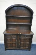 A 20TH CENTURY OAK DRESSER, the arched two tier plate rack atop a base with two drawers, over double
