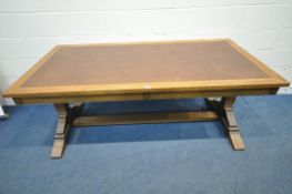IN THE MANNER OF A.W.N PUGIN, A 20TH CENTURY OAK LIBRARY TABLE, with a tanned leather writing