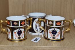 A GROUP OF THREE ROYAL CROWN DERBY LOVING CUPS comprising two Imari '1128' cups, both with pink