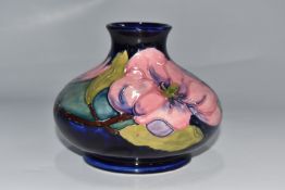 A MOORCROFT POTTERY 'MAGNOLIA' BULBOUS VASE on a blue ground, height 11.5cm x diameter 15cm (1) (