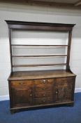 A GEORGIAN OAK DRESSER, the three tier plate rack atop a base with six assorted drawers, and two
