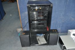 A TECHNICS COMPONENT HI FI SYSTEM IN BLACK ASH AND SMOKED GLASS CABINET, comprising of a SL-J110R