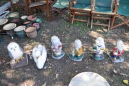 SIX CONCRETE GARDEN FIGURES, including four dwarfs, a swan planter and an owl (6)