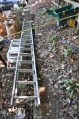 AN ALUMINIUM DOUBLE EXTENSION LADDER, with 17 rungs to each 420cm length (some rungs damaged) and
