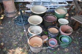 A COLLECTION OF SEVENTEEN GARDEN PLANT POTS, including glass, plastic, glazed and terracotta pots (