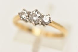 AN 18CT GOLD DIAMOND THREE STONE RING, three round brilliant cut diamonds, each in a white metal