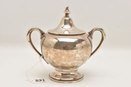 A CONTINETAL WHITE METAL SUGAR BOWL, polished form fitted with double scroll handle, together with a