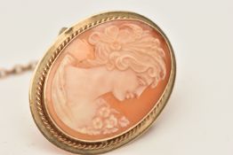 A 9CT GOLD CAMEO BROOCH, carved shell cameo depicting a lady in profile, collet set with a fine rope