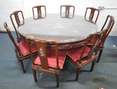 A LARGE CIRCULAR HUANGHUALI DINING TABLE, the mother of pearl chinoiserie inlay, with a glass
