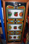 A DECORATIVE FRAMED NOVELTY PICTURE, designed to resemble the reels of a classical fruit machine,
