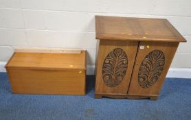 A 20TH CENTURY OAK DOUBLE DOOR CABINET, with foliate details, enclosing an assortment of shelves,