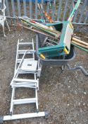 A WHEEL BARROW AND A QUANTITY OF GARDENING TOOLS, to include, rakes, shovels, forks, etc, and two
