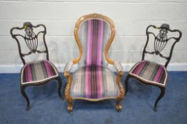 A VICTORIAN SPOON BACK ARMCHAIR, with stripped upholstery, open armrests, raised on front cabriole