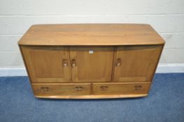 LUCIAN ERCOLANI, AN ERCOL MID-CENTURY ELM WINDSOR SIDEBOARD, fitted with three cupboard doors, the