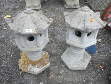 A PAIR OF COMPOSITE GARDEN ORNAMENTS, in the form of pagodas, height approximately 53cm, condition