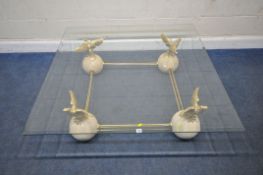 AN ITALIAN COFFEE TABLE, the square bevelled glass top with canted corners, raised on gilt brass