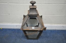 A METAL HANGING LANTERN, with four pierced plates, and four glass panes, one being a door,