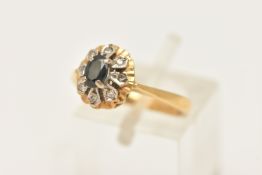 AN 18CT GOLD CLUSTER RING, a principally set oval cut sapphire, set with a surround of single cut