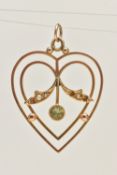 A LAVALIER PENDANT, an open work yellow metal heart form pendant, set with peridot and seed