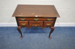 A REPRODUCTION MAHOGANY SIDE TABLE, fitted with four assorted drawers, raised on cabriole legs,