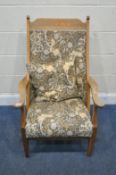 AN ARTS AND CRAFTS OAK ARMCHAIR, with swept open armrests, raised on square tapered front legs,
