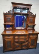 AN EARLY 20TH CENTURY WALNUT MIRROR BACK SIDEBOARD, the raised back with scrolled and foliate