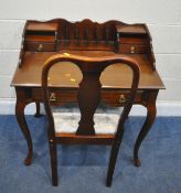 A REPRODUCTION MAHOGANY DESK, with various divisions, three assorted drawers, raised on cabriole