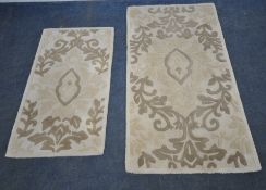 HOUSE OF BATH, TWO MATCHING RECTANGULAR RUGS, with repeating patterns, largest rug 151cm x 84cm,