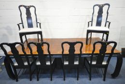 A REPRODUCTION ORIENTAL EXTENDING DINING TABLE with two additional leaves, raised on an ebonised