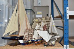 A COLLECTION OF ELEVEN DECORATIVE WOODEN BOATS to include HMS Victory, Cutty Sark, a large sailing