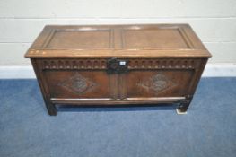 A GEORGIAN OAK COFFER, the hinged lid enclosing a candle box, the front with repeating geometric