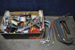 A CARDBOARD BOX CONTAINING VARIOUS HAND TOOLS, to include three woden G clamps, three saws, some