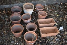 A SELECTION OF TERRACOTTA PLANT POTS, of various sizes, along with two rectangular planters,