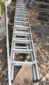 AN ALUMINIUM TRIPLE EXTENSION LADDER with nine rungs to each 260cm length and a double extension