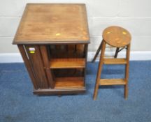 AN EDWARDIAN MAHOGANY REVOLVING BOOKCASE, 49cm squared x height 77cm, along with a set of small step