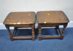 A PAIR OF ERCOL ELM AND BEECH TABLES, raised on block and turned legs, united by stretchers, width