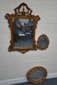 A MODERN WALL MIRROR, with scrolled and foliate details, 73cm x 107cm along with two gilt resin wall